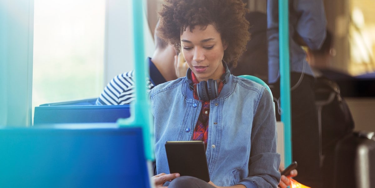 woman on a bus looking at phone