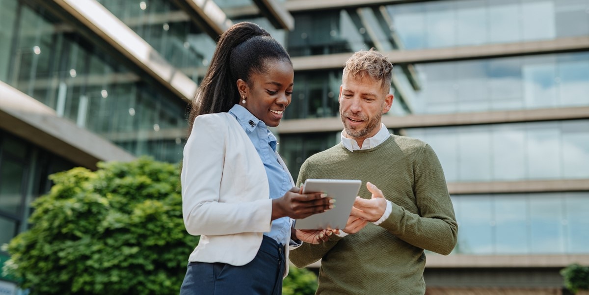 two professionals looking at document