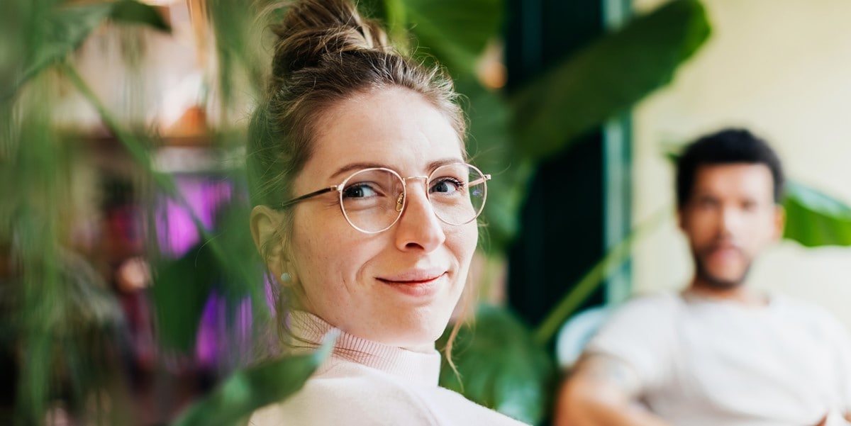 woman smiling, man in the background